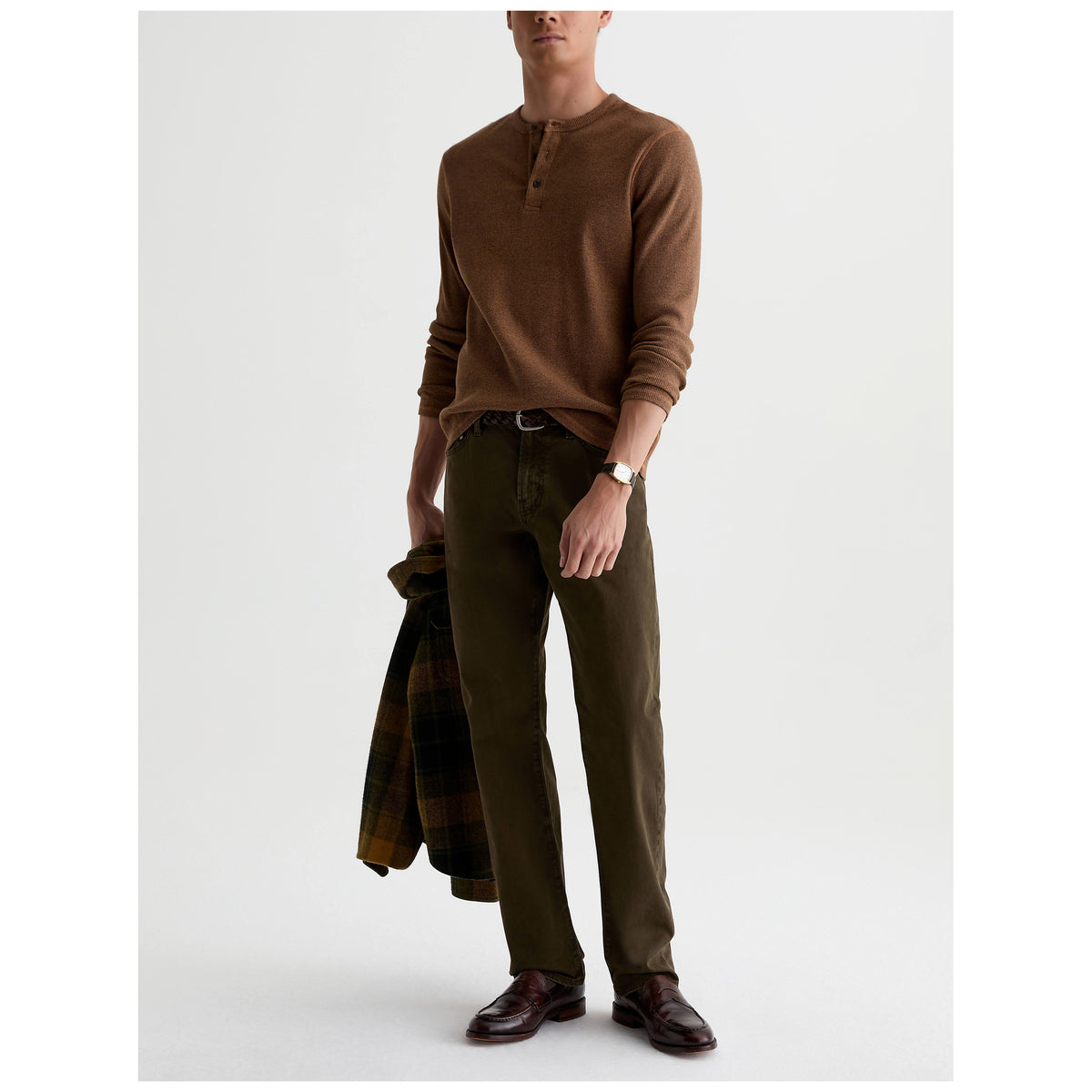 Male model wearing olive green AG Everett Sueded Sateen pants with brown henley