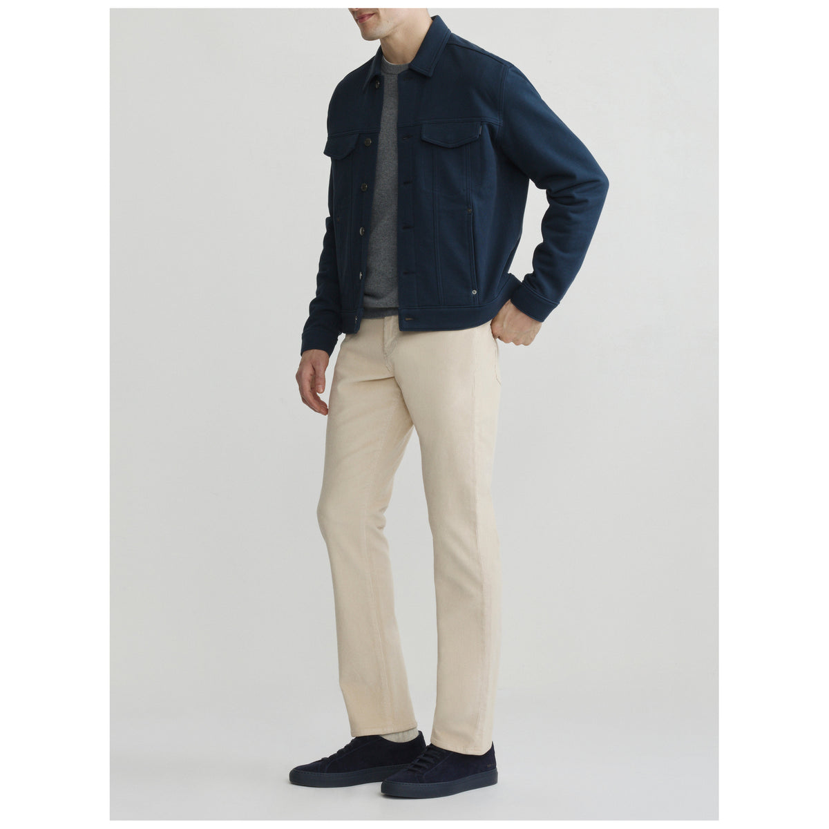 Male model wearing DL1961 Russell Slim Straight corduroy pants in Frostline cream color