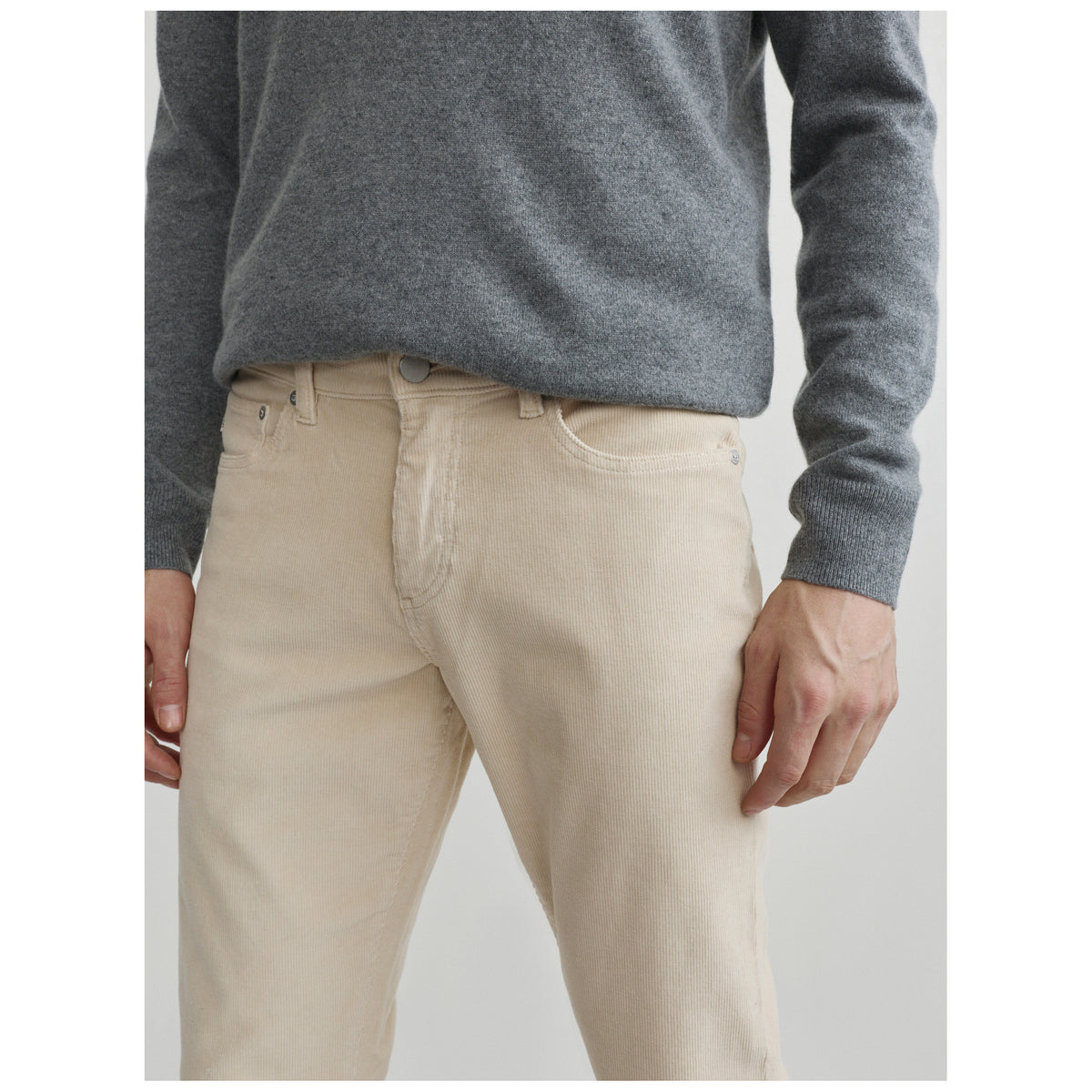 Model wearing DL1961 Russell slim straight corduroy pants in light frostline beige