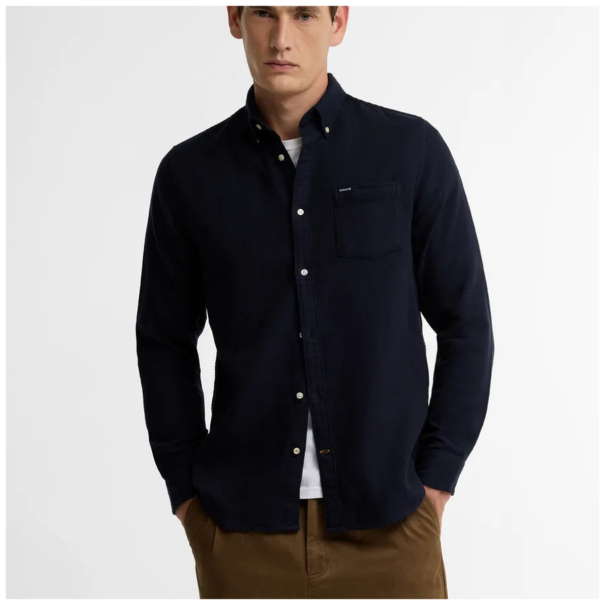 Male model wearing Barbour navy herringbone button-down shirt with chest pocket over white tee