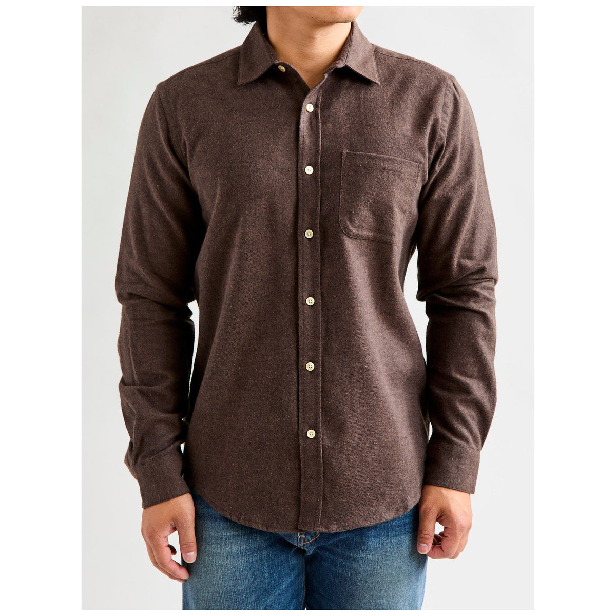 Model wearing Portuguese Flannel Teca Flannel Shirt in dark brown with cream buttons