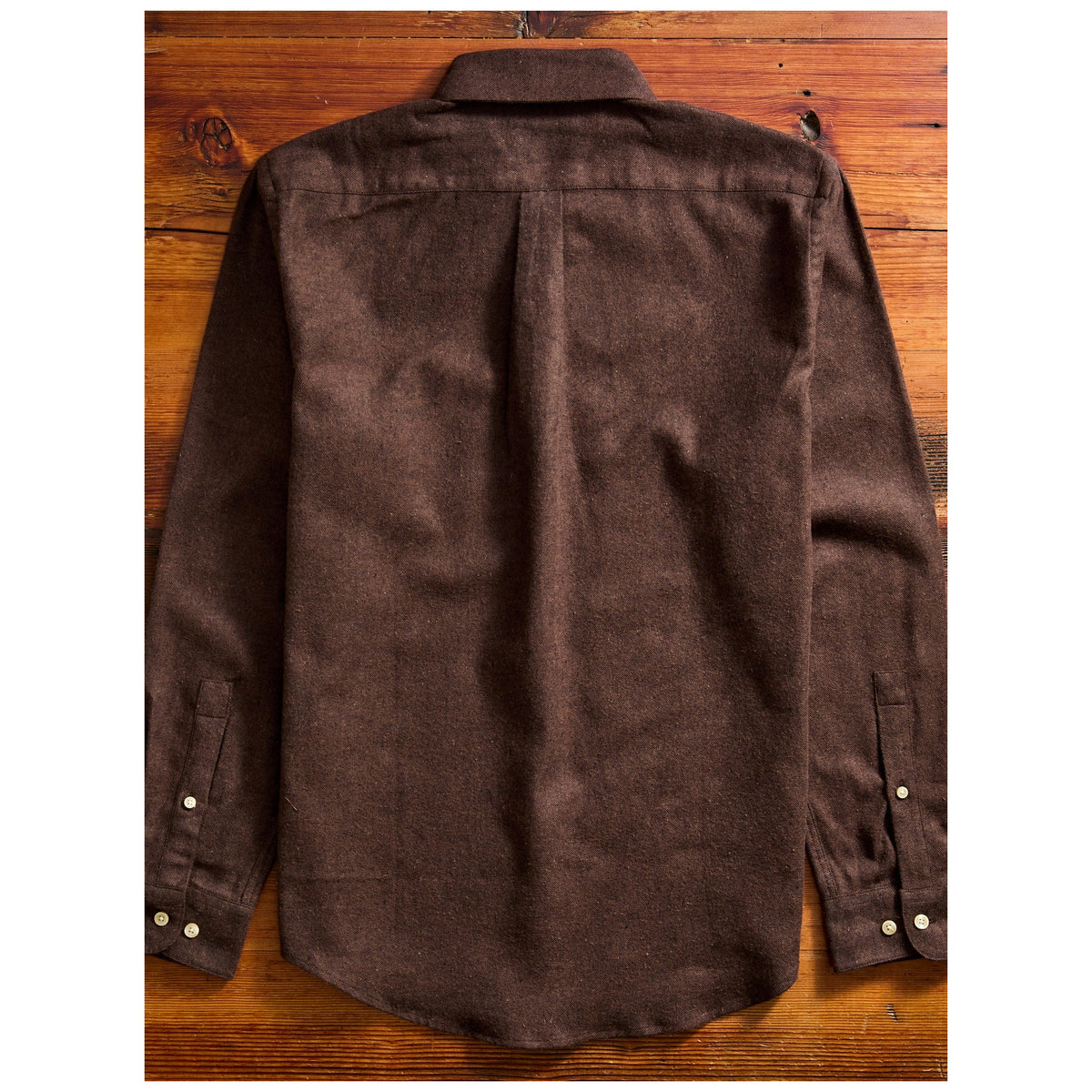 Portuguese Flannel Teca Flannel Shirt in dark brown, back view flat lay on wooden surface