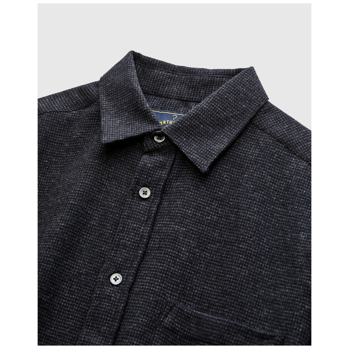 Portuguese Flannel Sounds Flannel shirt folded showing collar and pearl buttons in dark navy