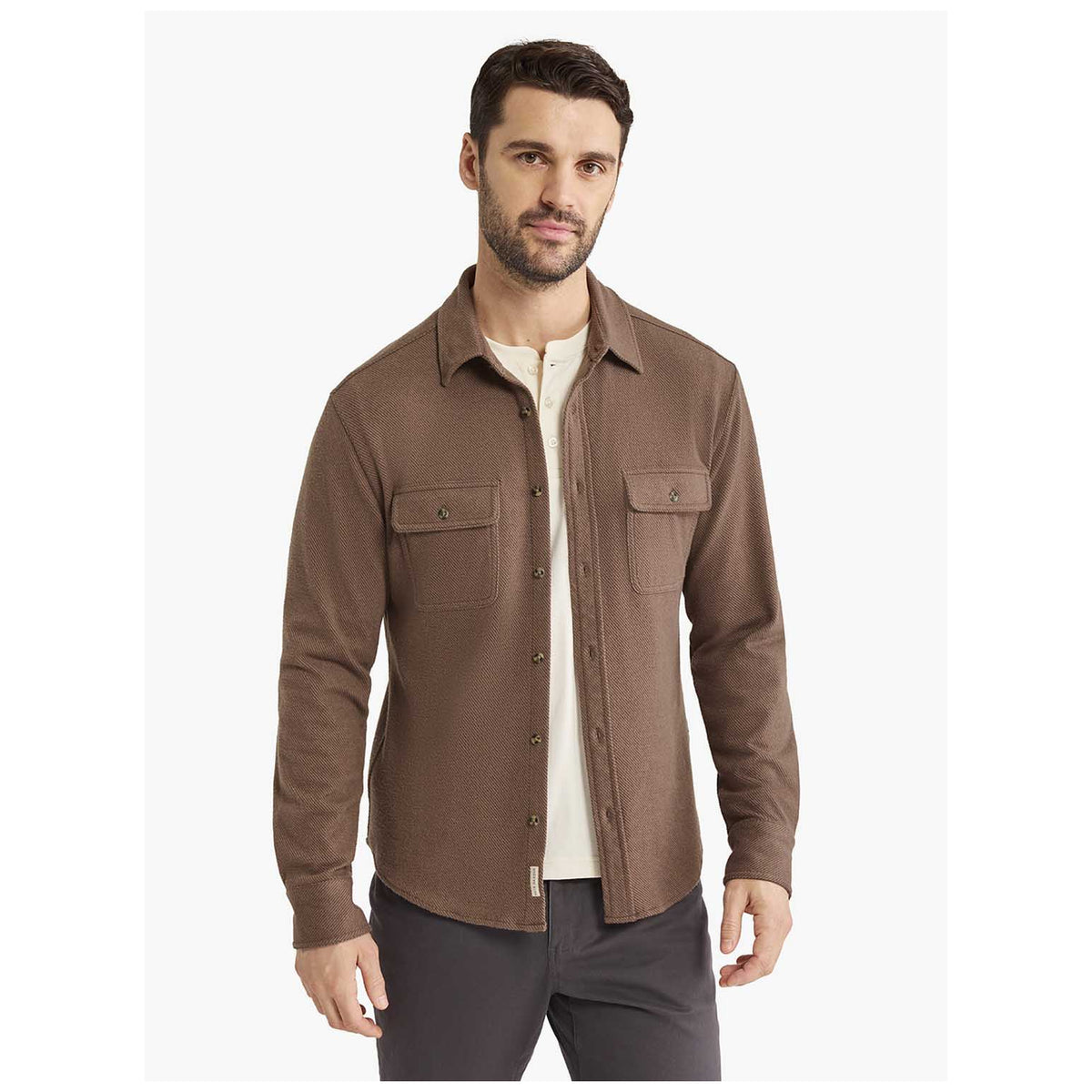 Male model wearing Fair Harbor Dunewood Flannel Shirt in warm espresso brown twill over white henley