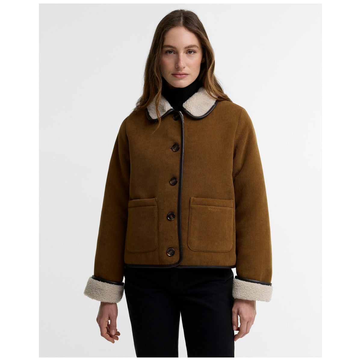 Woman wearing tan corduroy Barbour Penny Fleece jacket with ecru shearling collar and cuffs