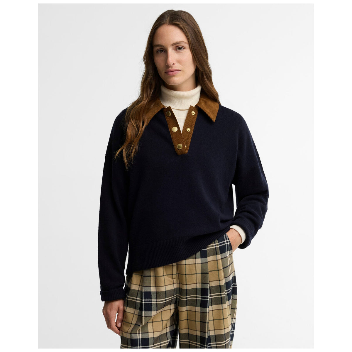 Woman wearing navy Barbour Ravenshill knitted jumper with corduroy collar and plaid trousers