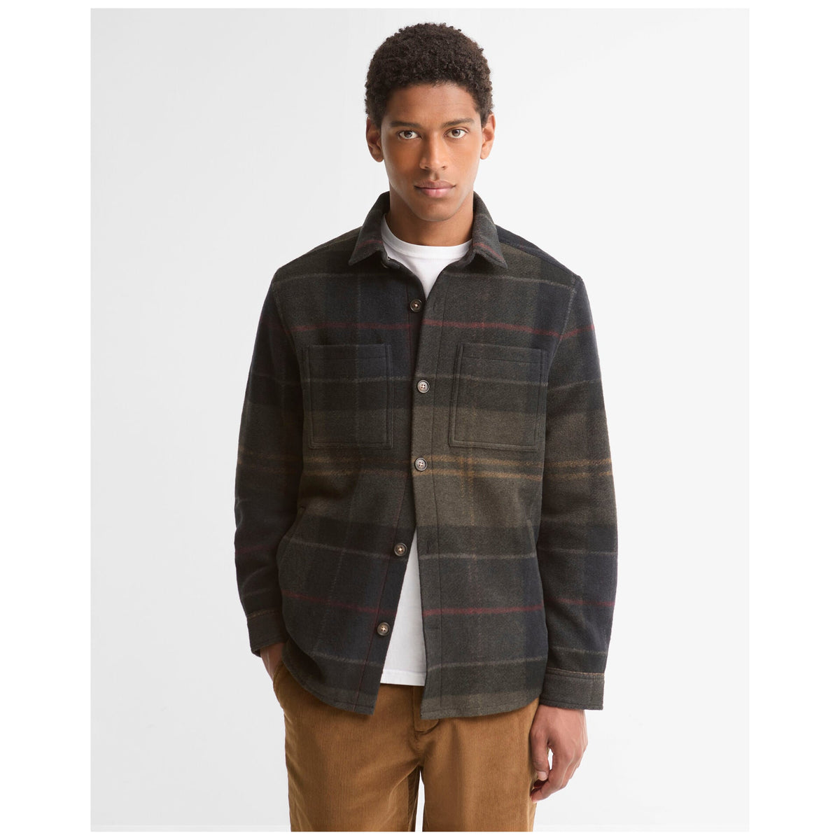 Male model wearing Barbour Woodlane Brushed Check Overshirt in dark Shadow Classic Tartan plaid