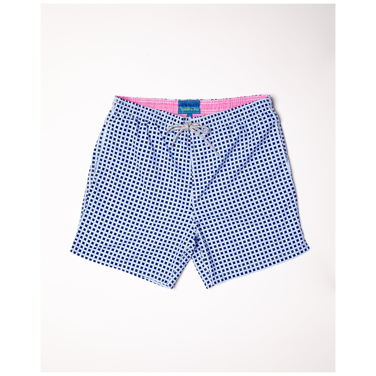 Navy swim trunks with white square pattern and pink waistband trim