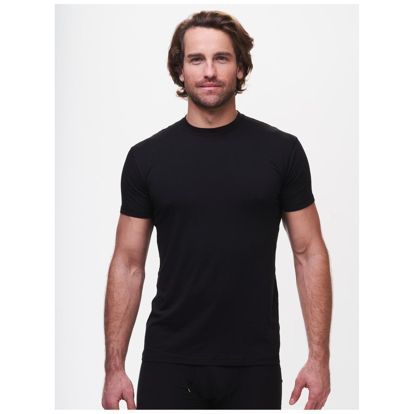 Man wearing black crew neck undershirt in professional studio photo