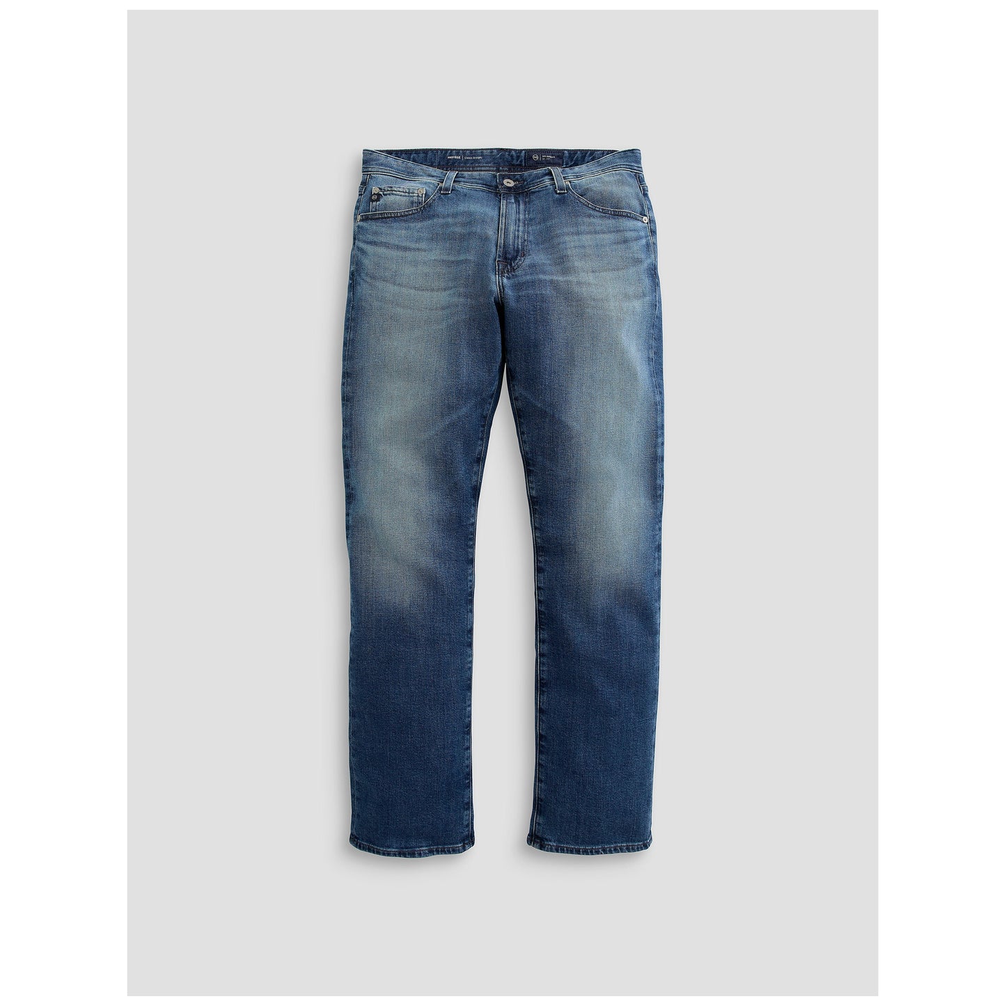 Medium wash blue straight leg denim jeans laid flat on light background