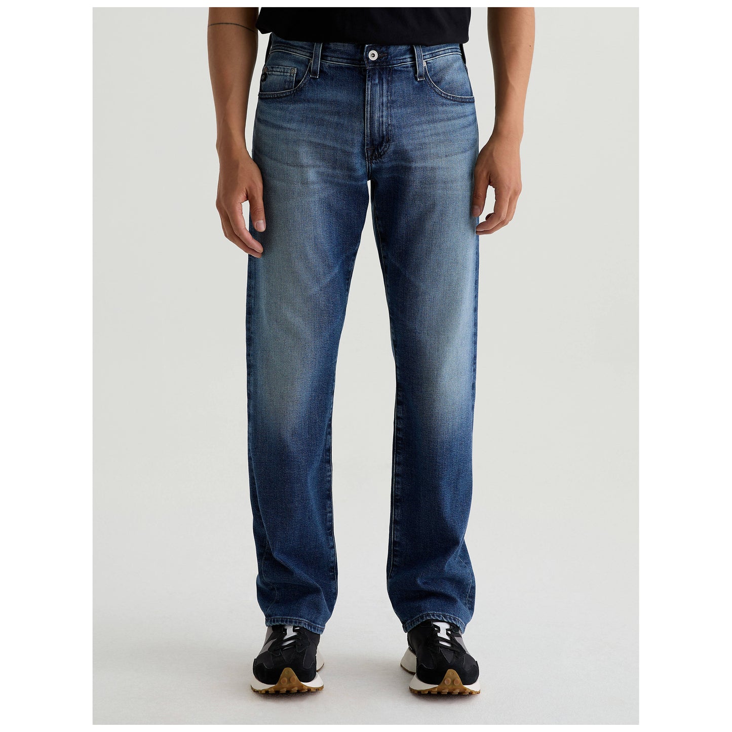 Model wearing AG Jeans Protege Classic Straight Jeans in medium blue denim wash
